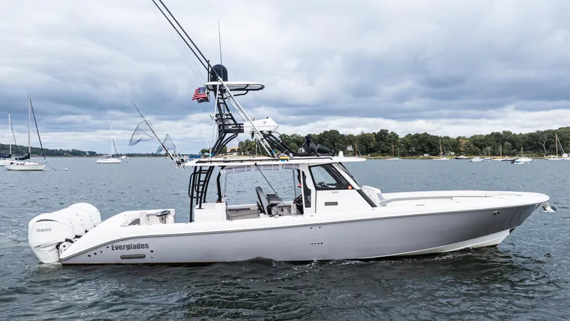  Yacht Photos Pics 2017 Everglades 435 CC boat on water, with fishing rods and American flag.