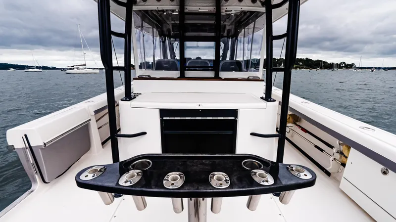  Yacht Photos Pics 2017 Everglades 435 CC boat interior with rod holders, on a calm water backdrop.