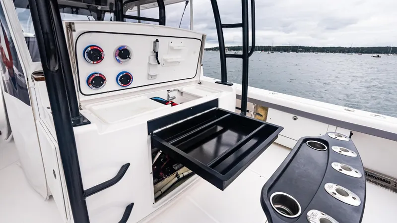  Yacht Photos Pics 2017 Everglades 435 CC boat interior with open storage drawer and control panel.