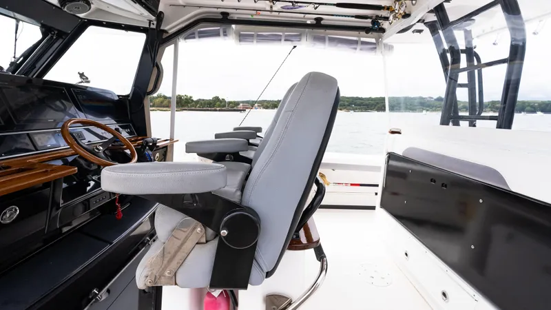  Yacht Photos Pics Interior of 2017 Everglades 435 CC boat with steering wheel and seating.