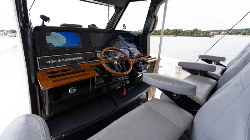  Yacht Photos Pics 2017 Everglades 435 CC boat cockpit with modern navigation equipment and comfortable seating.