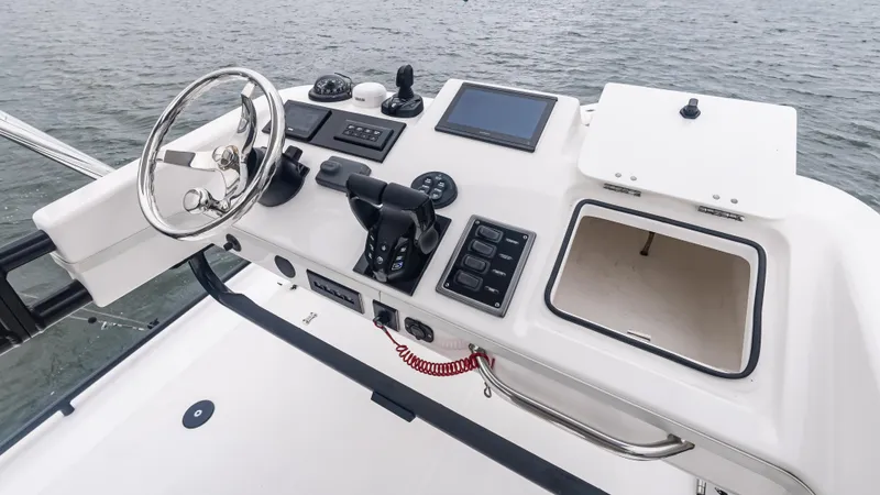  Yacht Photos Pics Control panel of a 2017 Everglades 435 CC boat, featuring steering wheel and navigation equipment.