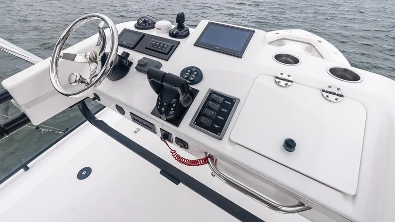  Yacht Photos Pics Control panel of 2017 Everglades 435 CC boat with steering wheel and navigation equipment.