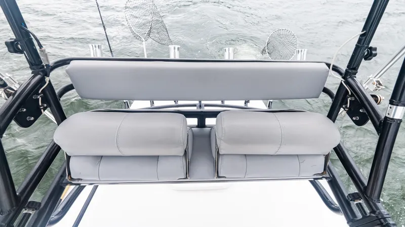  Yacht Photos Pics 2017 Everglades 435 CC boat seating with fishing rod holders on a calm sea.