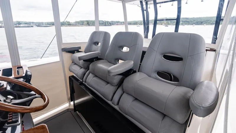  Yacht Photos Pics Three gray seats in the cockpit of a 2017 Everglades 435 CC boat.