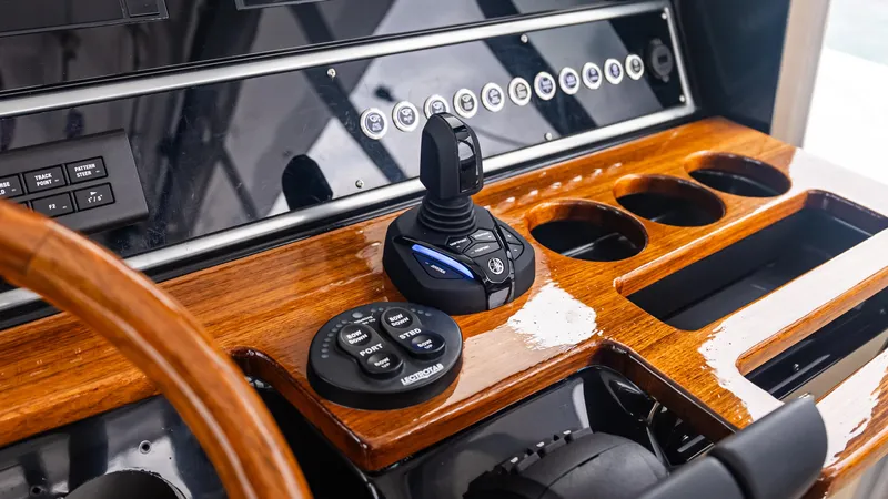  Yacht Photos Pics Control panel of 2017 Everglades 435 CC boat with joystick and wooden finish.