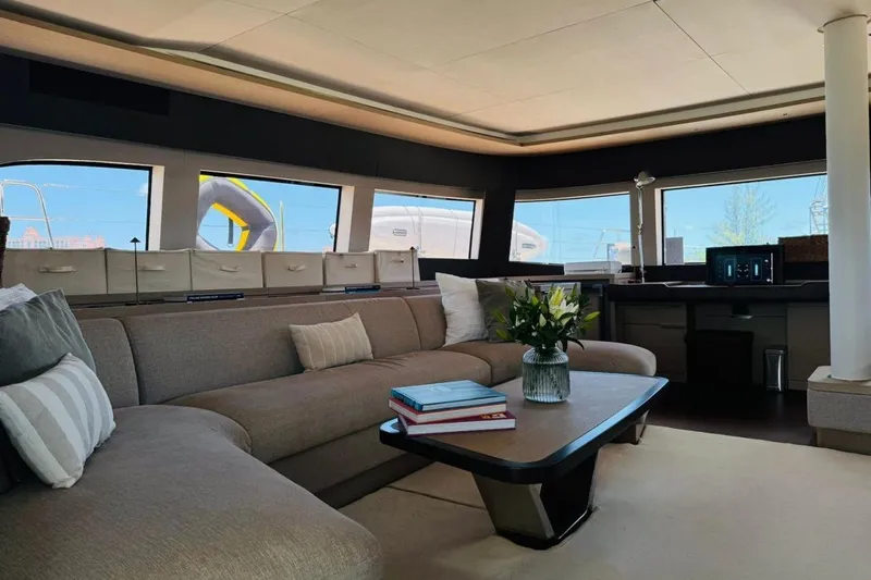 El Nino Yacht Photos Pics Luxurious interior of 2024 Lagoon 65 yacht with modern furnishings and panoramic windows.