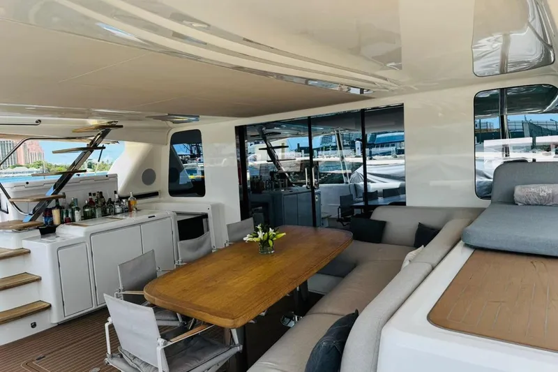 El Nino Yacht Photos Pics Luxurious interior of 2024 Lagoon 65 yacht with dining area and bar setup.