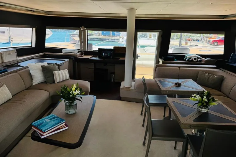 El Nino Yacht Photos Pics Luxurious interior of 2024 Lagoon 65 yacht with elegant seating and dining area.