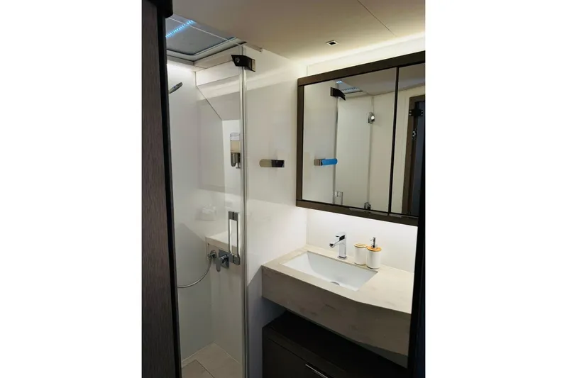 El Nino Yacht Photos Pics Modern bathroom interior of 2024 Lagoon 65 yacht, featuring sleek sink and shower design.