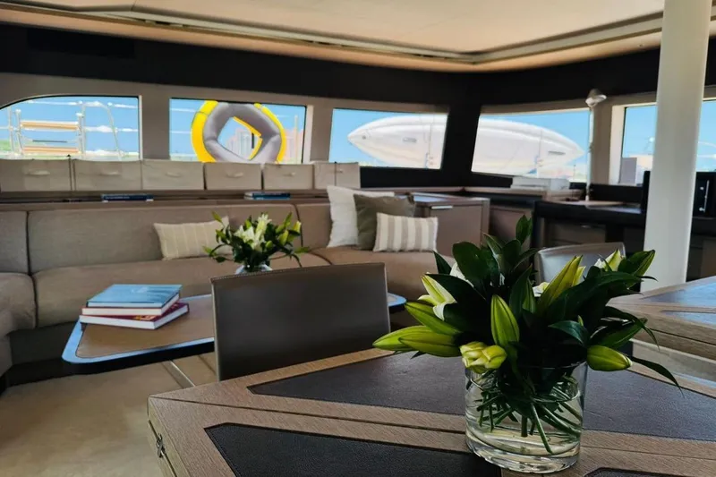 El Nino Yacht Photos Pics Luxurious interior of 2024 Lagoon 65 yacht with elegant decor and panoramic windows.