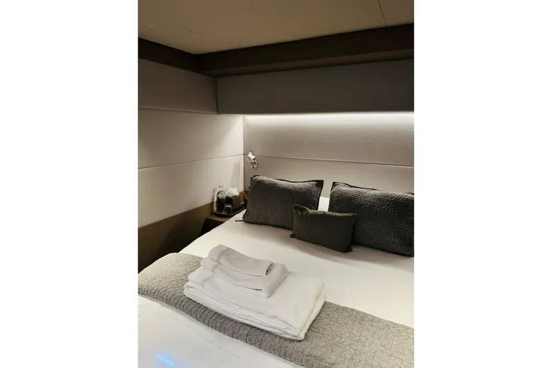 El Nino Yacht Photos Pics Luxurious bedroom interior of 2024 Lagoon 65 yacht with elegant bedding and soft lighting.