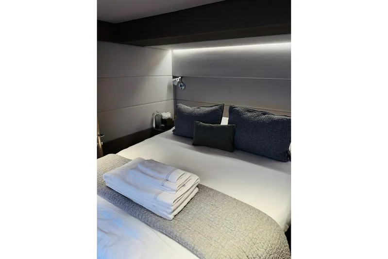El Nino Yacht Photos Pics Luxurious bedroom interior of 2024 Lagoon 65 yacht with neatly arranged bedding.