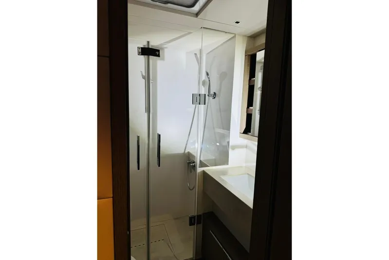 El Nino Yacht Photos Pics Modern bathroom in 2024 Lagoon 65 yacht with glass shower enclosure.