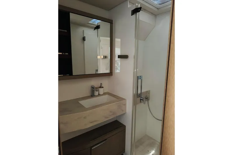 El Nino Yacht Photos Pics Modern bathroom in 2024 Lagoon 65 yacht with sleek shower and vanity.