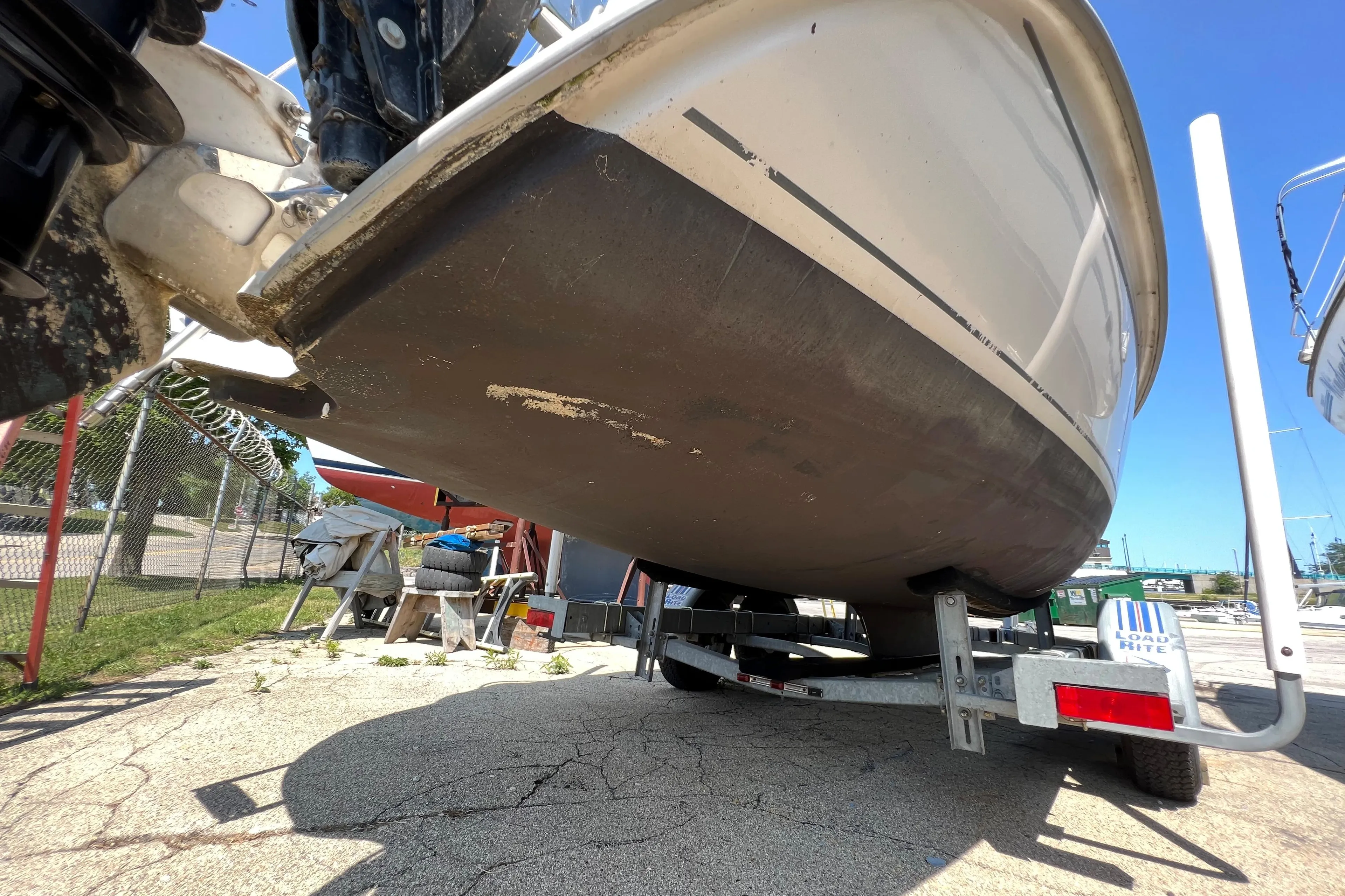 2007 Hunter 25 boat on trailer, showing hull and motor in a sunny outdoor setting.