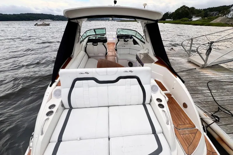  Yacht Photos Pics 2014 Sea Ray SLX 350 boat with luxurious seating, docked by a scenic waterfront.