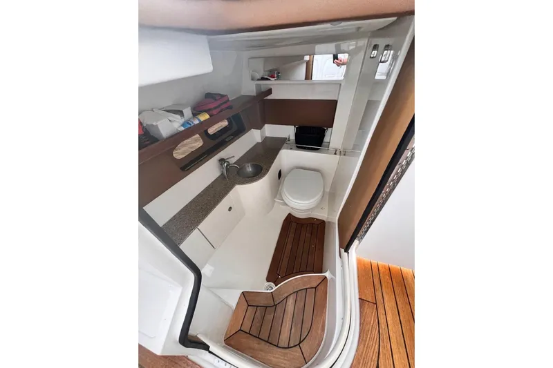  Yacht Photos Pics 2014 Sea Ray SLX 350 boat interior with sink, toilet, and wooden flooring.
