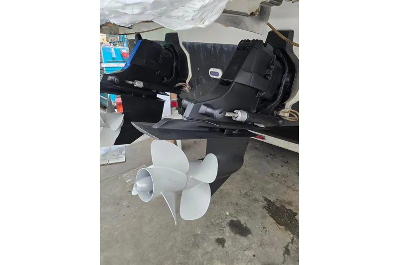  Yacht Photos Pics 2014 Sea Ray SLX 350 boat propellers and outdrive in a workshop setting.