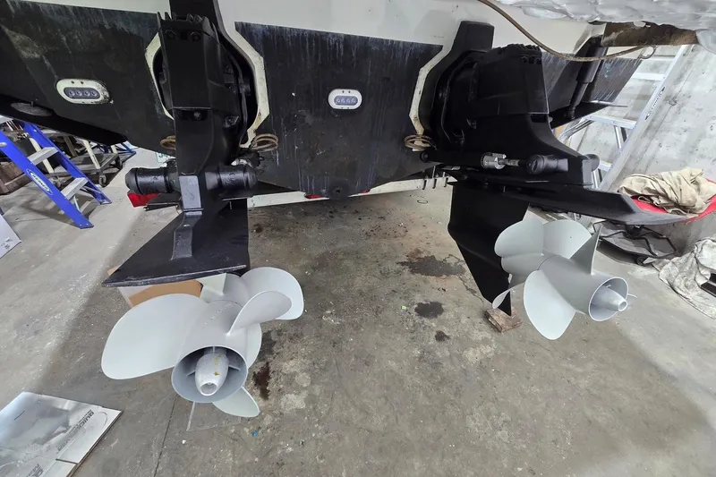  Yacht Photos Pics 2014 Sea Ray SLX 350 boat propellers in a workshop setting.