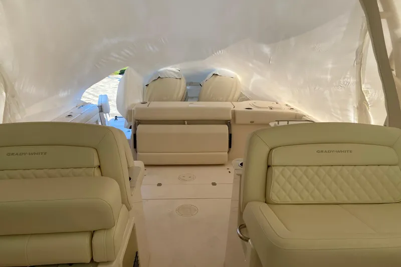  Yacht Photos Pics 2026 Grady-White Freedom 325 boat interior with luxurious seating and protective cover.