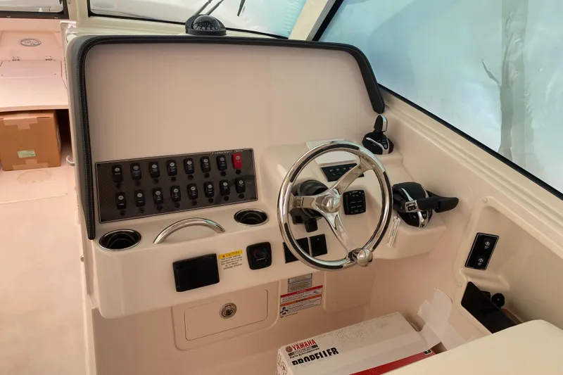  Yacht Photos Pics 2026 Grady-White Freedom 325 boat helm with steering wheel and control panel.