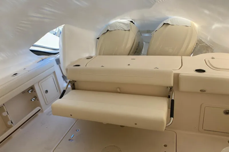  Yacht Photos Pics 2026 Grady-White Freedom 325 boat interior with seating and covered engines.