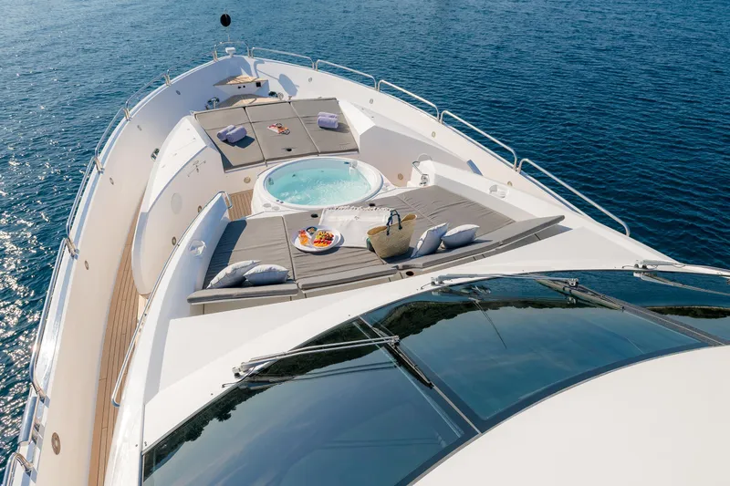  Yacht Photos Pics Luxurious Sunseeker Predator 108 yacht deck with jacuzzi, sun loungers, and ocean view.
