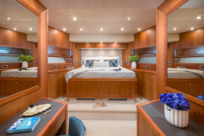  Yacht Photos Pics Luxurious bedroom interior of 2008 Sunseeker Predator 108 yacht with elegant wood finishes.