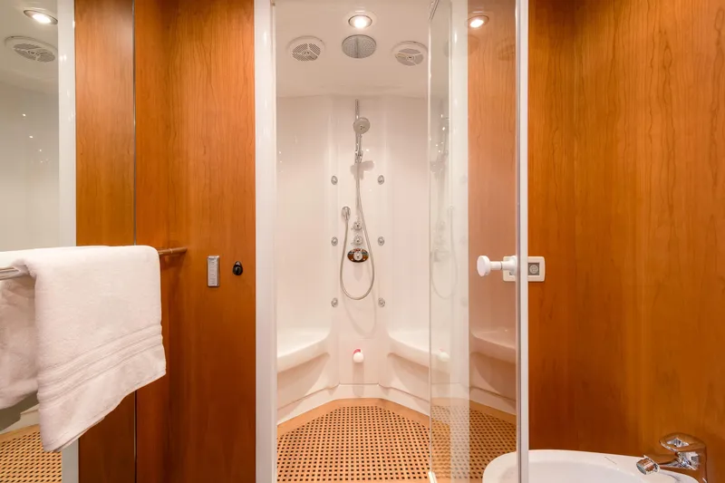  Yacht Photos Pics Luxurious shower area in 2008 Sunseeker Predator 108 yacht, featuring wooden accents and modern fixtures.