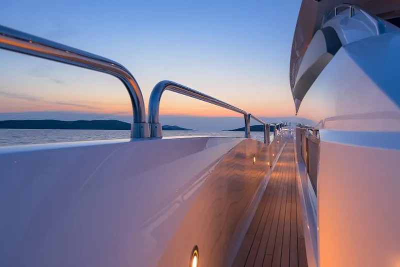  Yacht Photos Pics Side view of 2008 Sunseeker Predator 108 yacht at sunset, featuring sleek design and ocean backdrop.