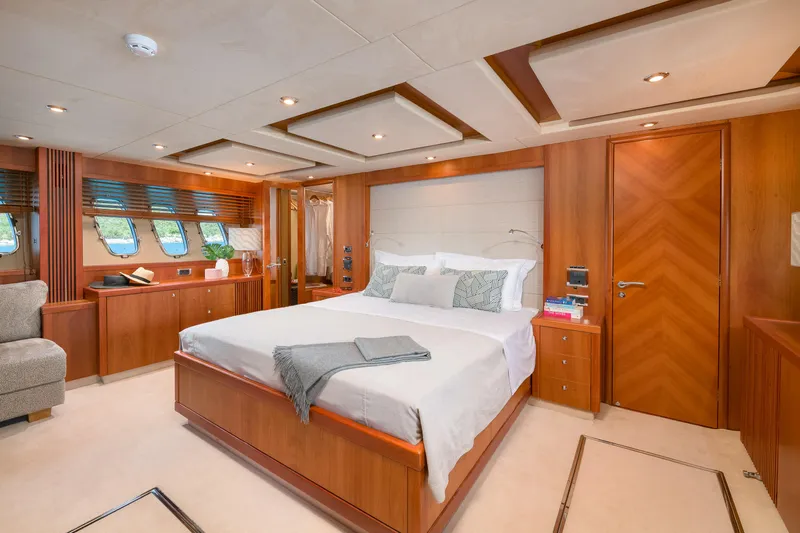  Yacht Photos Pics Luxurious bedroom interior of 2008 Sunseeker Predator 108 yacht, featuring elegant wood finishes.