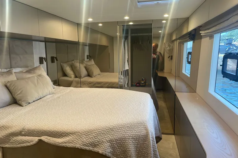 Ksenia Yacht Photos Pics Luxurious bedroom interior of 2024 Sunreef 60 yacht with modern design and large windows.