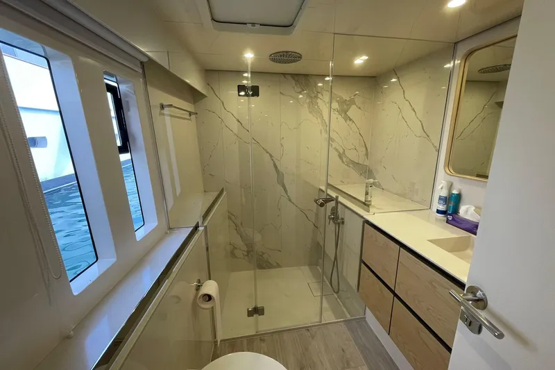 Ksenia Yacht Photos Pics Luxurious bathroom in 2024 Sunreef 60 yacht with modern shower and elegant design.