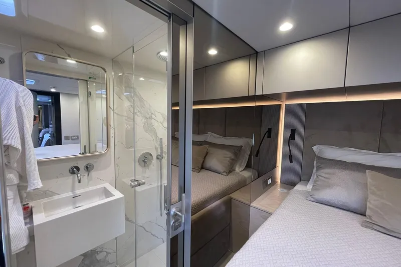 Ksenia Yacht Photos Pics Luxurious interior of 2024 Sunreef 60 yacht featuring modern bedroom and elegant bathroom.