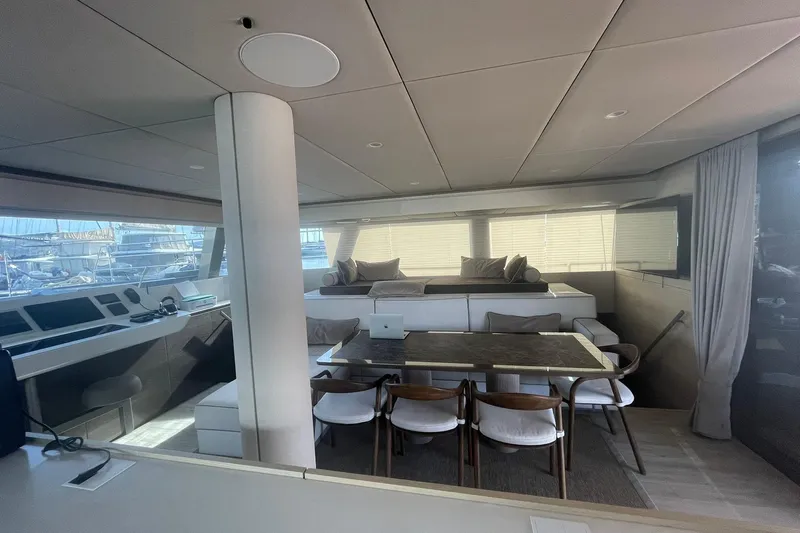Ksenia Yacht Photos Pics Luxurious interior of 2024 Sunreef 60 yacht with modern dining area and seating.