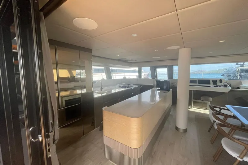 Ksenia Yacht Photos Pics Luxurious interior of 2024 Sunreef 60 yacht with modern kitchen and panoramic windows.