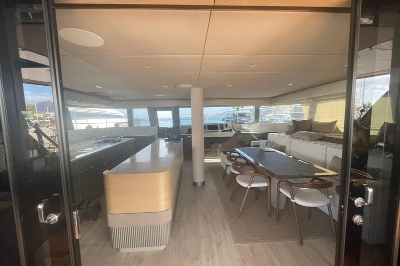 Ksenia Yacht Photos Pics Luxurious interior of 2024 Sunreef 60 yacht with modern dining and lounge area.