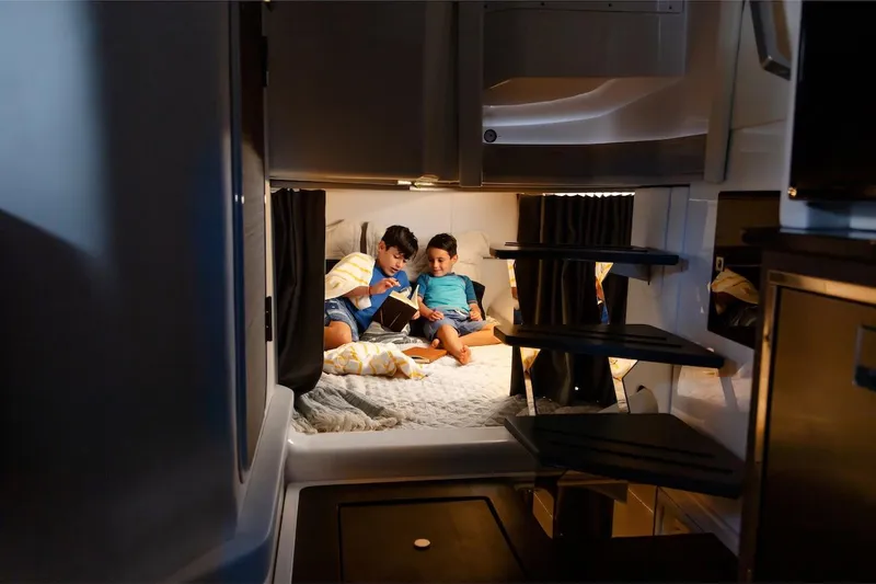  Yacht Photos Pics Manufacturer Provided Image: Children reading in cozy cabin of 2023 Aviara AV40 OB boat.