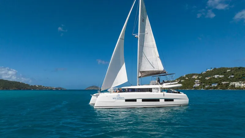  Yacht Photos Pics Sailing Dufour Catamarans 48, 2021 model, on clear blue waters under a sunny sky.