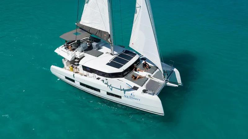  Yacht Photos Pics 2021 Dufour Catamarans 48 sailing on clear turquoise waters.