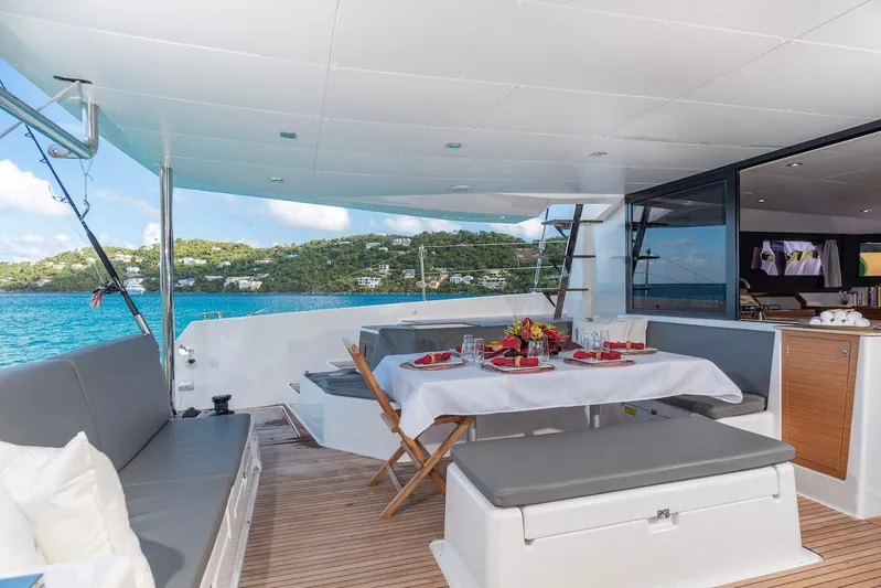  Yacht Photos Pics Luxurious 2021 Dufour Catamarans 48 yacht with elegant outdoor dining area and scenic ocean view.
