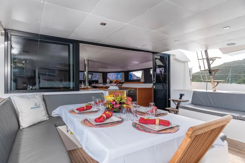 Yacht Photos Pics Luxurious dining area on a 2021 Dufour Catamarans 48, elegantly set with vibrant decor.