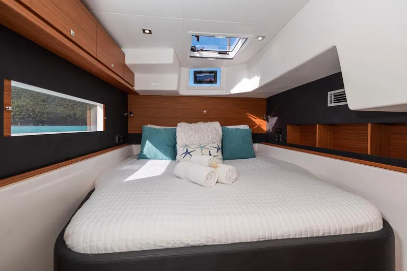  Yacht Photos Pics Luxurious cabin interior of 2021 Dufour Catamarans 48 with cozy bed and modern design.