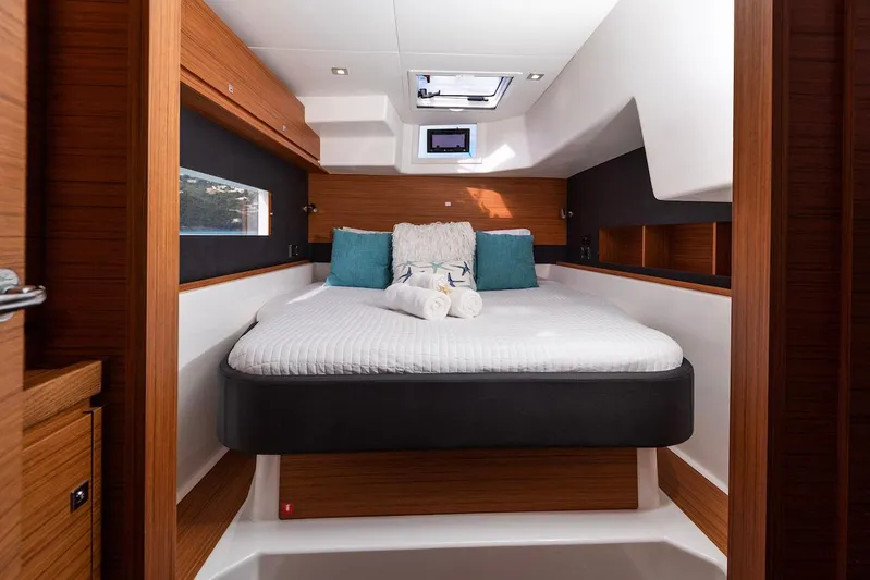  Yacht Photos Pics Luxurious cabin interior of 2021 Dufour Catamarans 48 with cozy bed and modern design.