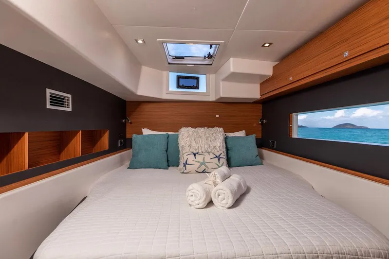  Yacht Photos Pics Luxurious cabin interior of 2021 Dufour Catamarans 48 with ocean view and plush bedding.