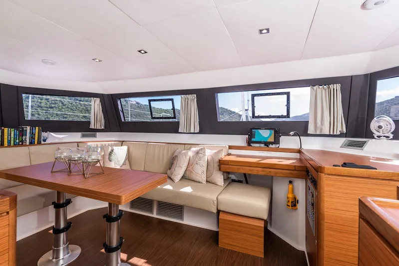  Yacht Photos Pics Luxurious interior of 2021 Dufour Catamarans 48 with modern seating and panoramic windows.