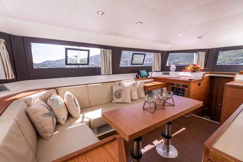  Yacht Photos Pics Luxurious interior of 2021 Dufour Catamarans 48 with elegant seating and panoramic windows.