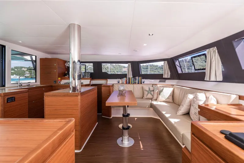  Yacht Photos Pics Luxurious interior of 2021 Dufour Catamarans 48 with modern wood finish and spacious seating.