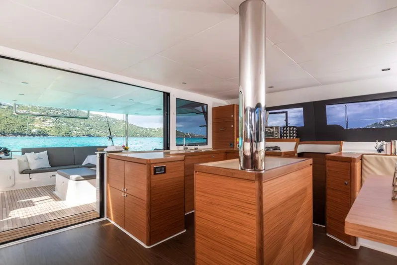  Yacht Photos Pics Interior of 2021 Dufour Catamarans 48, featuring modern wood cabinetry and ocean view.